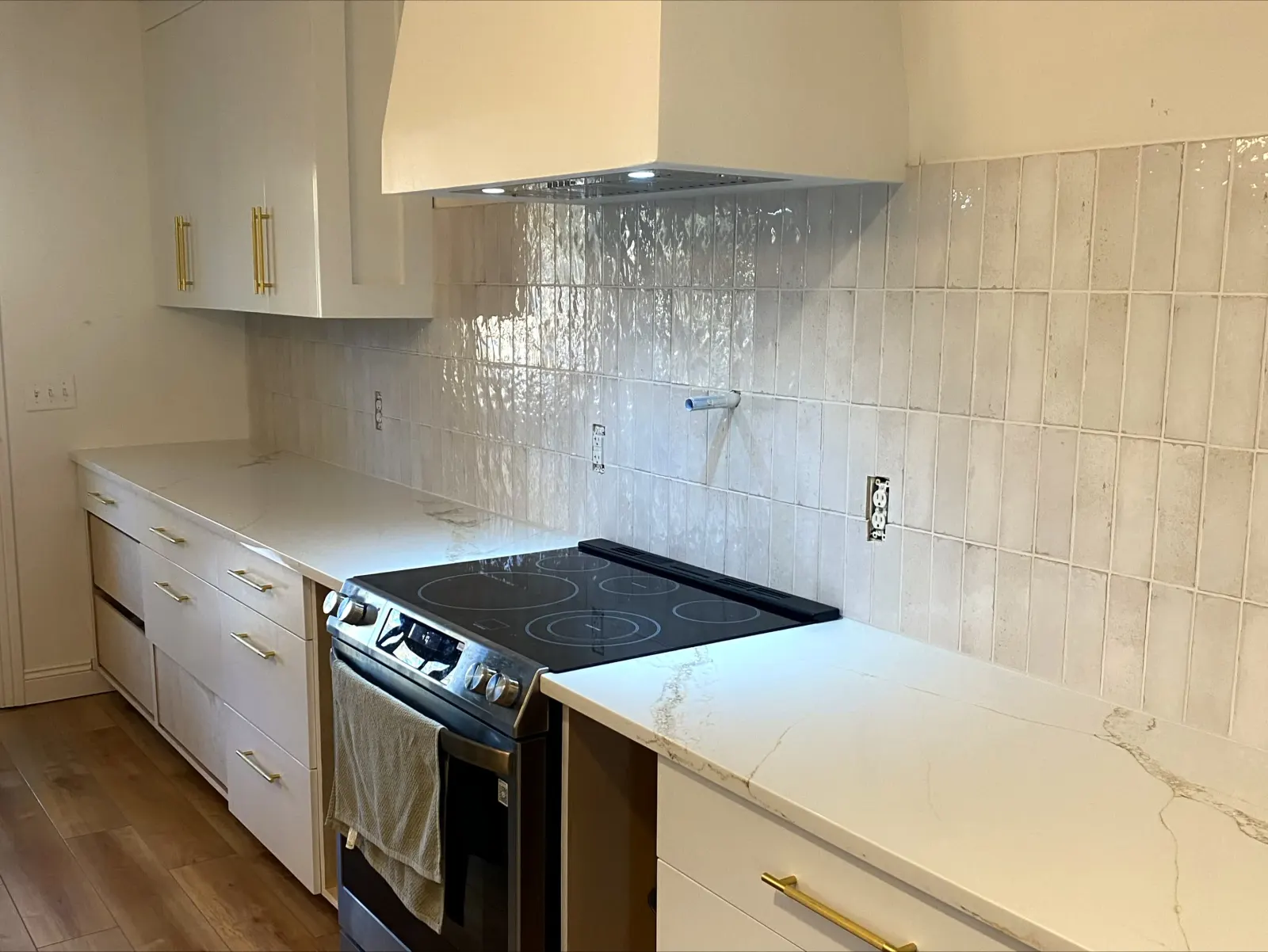 Kitchen cabinets with white vertical tile backsplash