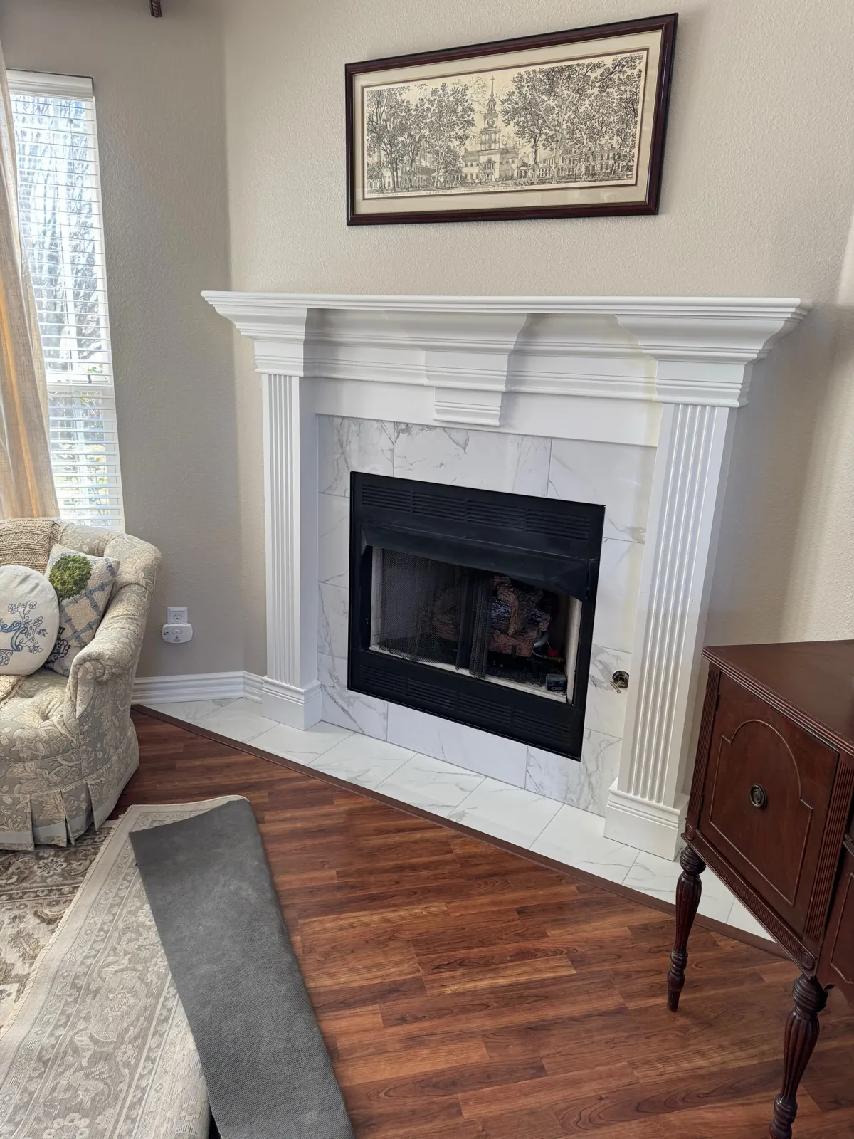 Finished mantel with marble tile and hardwood floor