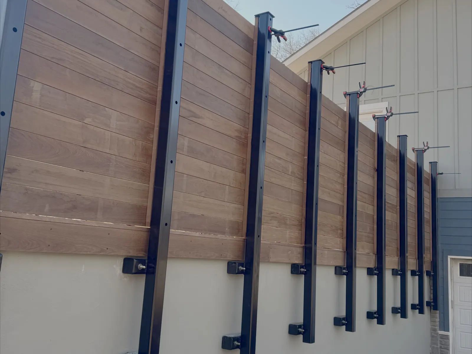 Hardwood privacy fence on steel posts