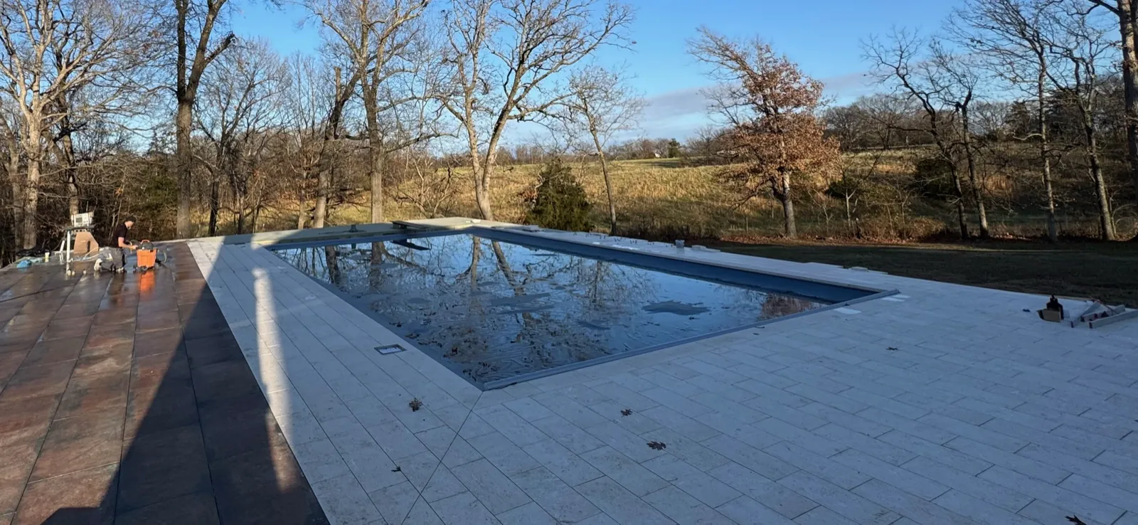 Pool with travertine deck and countryside view