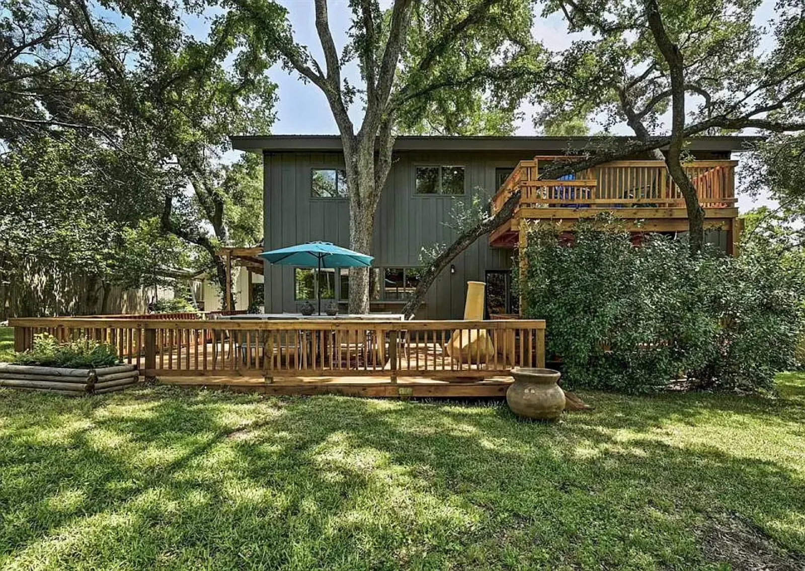 Multi-level wood deck behind a modern home