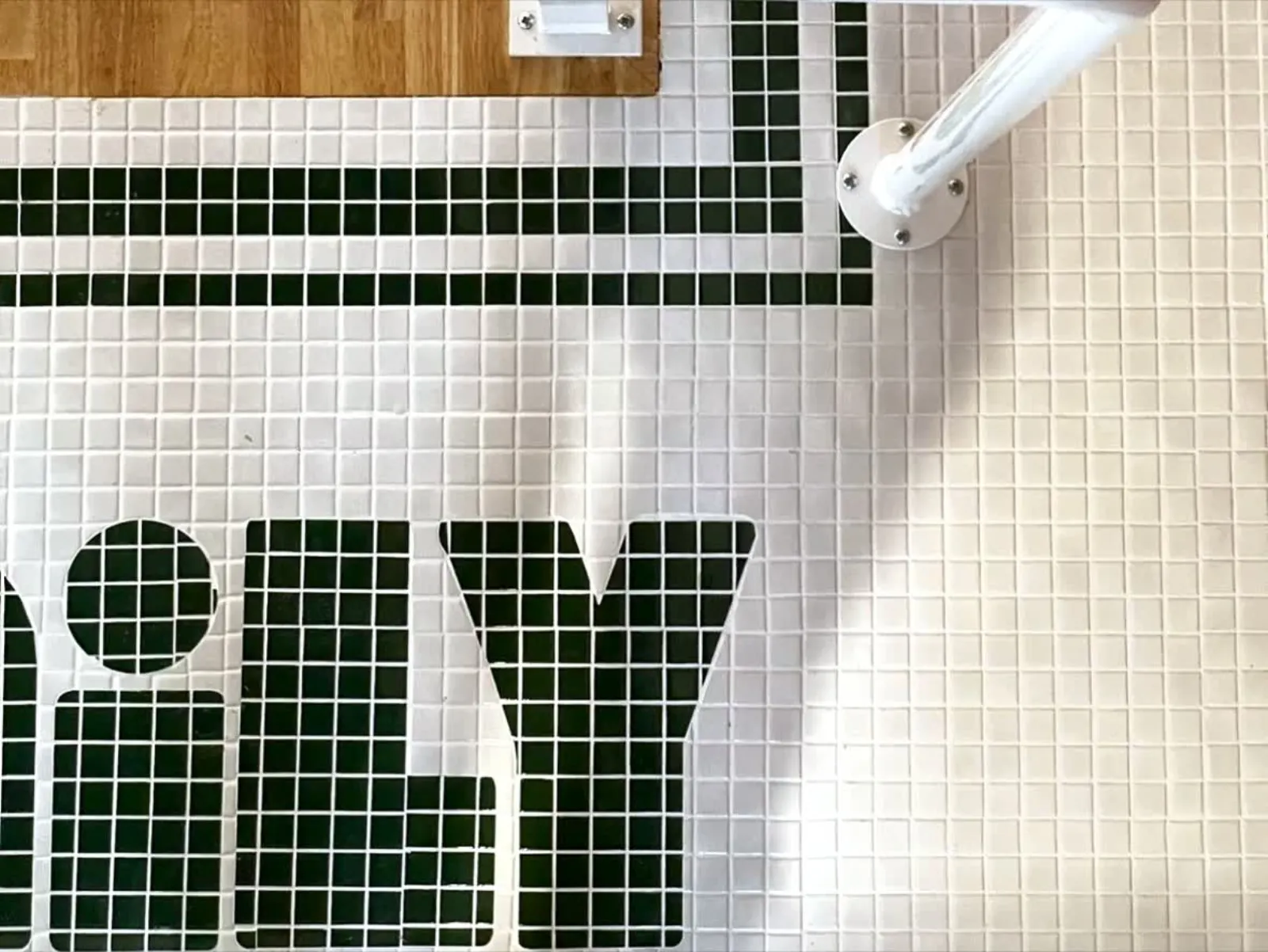 Green and white mosaic tile lettering