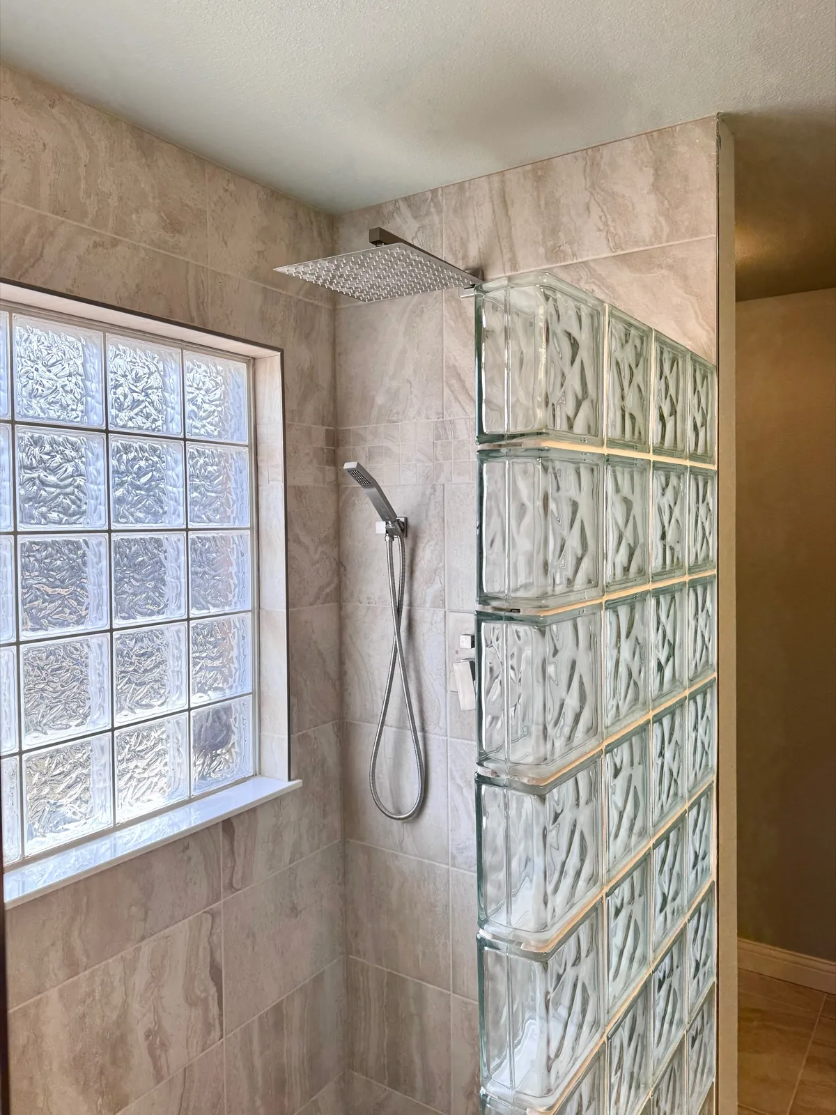 Glass block shower wall with rain shower head